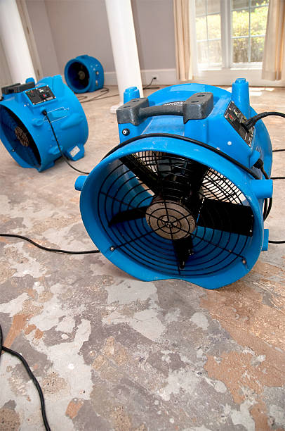 Technician operating a water damage fan